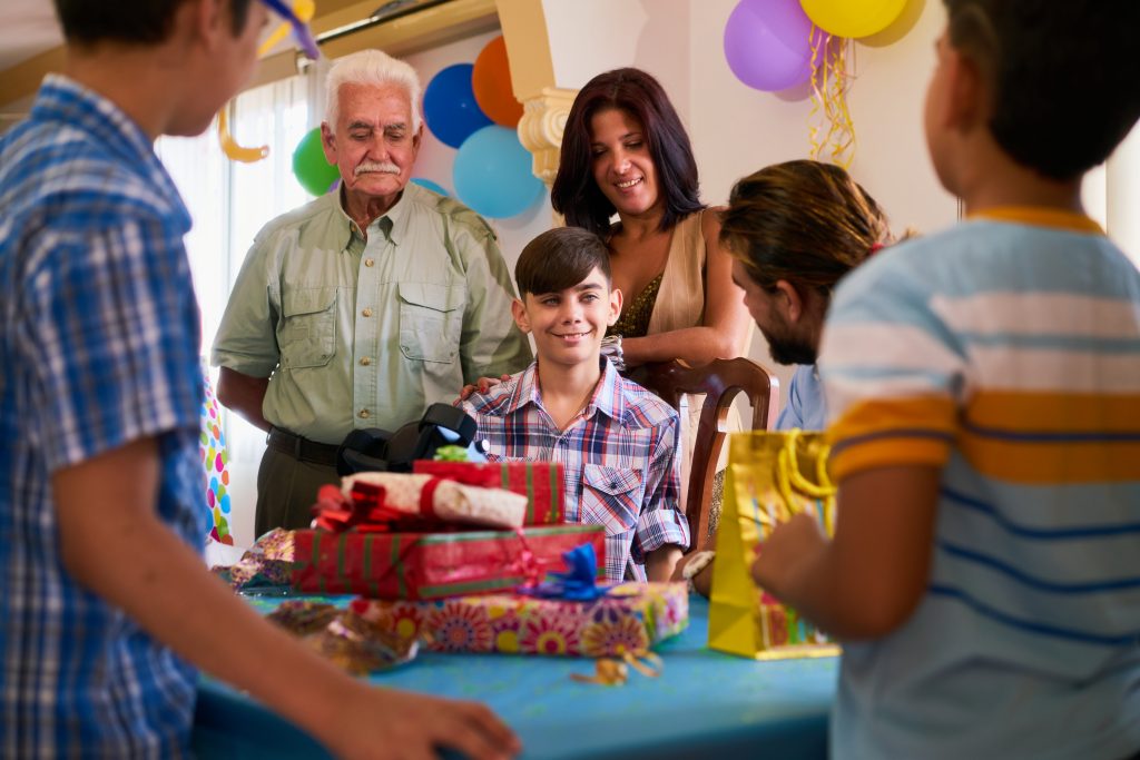 Boy With Family And Friends Celebrating Birthday Party
